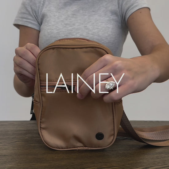 A video of a Woman showing the features and benefits of a Modern + Chic Lainey Convertible Crossbody Bag for Women. 